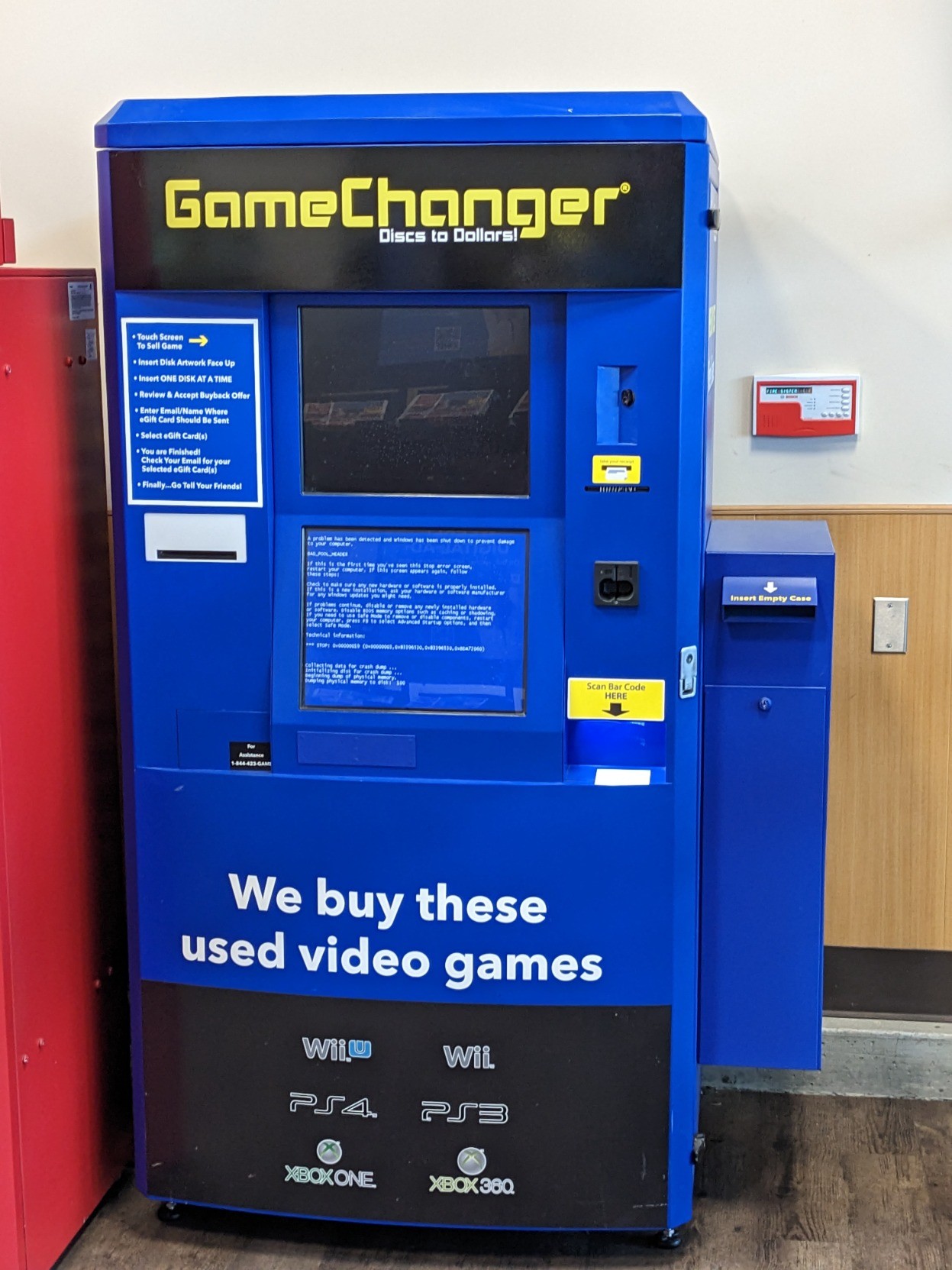 A "GameChanger" kiosk for selling used video games including Xbox 360 and Wii titles, apparently. Its screen is showing some variant of a Blue Screen of Death.